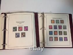 Two vintage The Heritage Collection stamp albums loaded with unhinged USA stamps