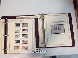 Two vintage The Heritage Collection stamp albums loaded with unhinged USA stamps