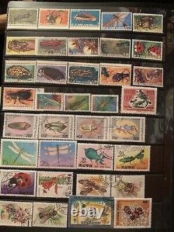 Worldwide stamps collections lots in album mint & used animals cars insects