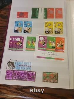 Collection de timbres du monde entier dans un album plein de timbres neufs et utilisés Royal Mail HK