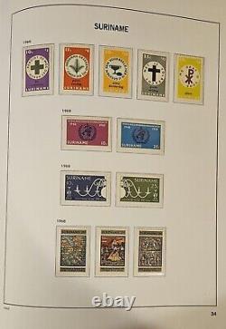 Collection du Suriname dans l'album sans charnière Davo Vol. 1 avec des timbres principalement neufs non charniérés