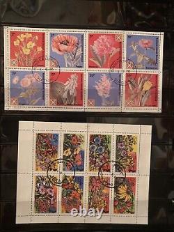 Collections de timbres du monde entier en lot dans un album, timbres utilisés de fleurs et d'animaux.